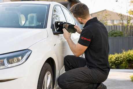 rideshare driver mirror repair Melbourne - technician fitting a side mirror on a sedan in a suburban driveway